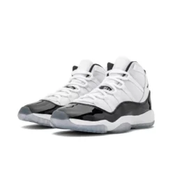 Jordan 11 Retro Concord (2018) (GS), Air Jordan 11 Concord, grade school basketball sneakers, black and white Jordans, stylish high tops, Nike Air Jordan, classic design, limited edition Jordans, kids' sneaker collection, urban fashion sneakers, Concord colorway, retro sneaker design, Jordan brand shoes, premium materials, iconic Jordans, comfortable fit, streetwear style, collector's edition Jordans, shiny patent leather, durable kids' footwear.