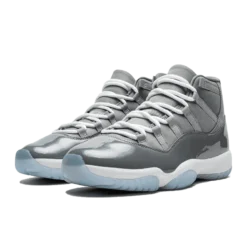 Jordan 11 Retro Cool Grey (2021), Air Jordan 11 Cool Grey, grey and white Jordans, stylish high tops, Nike Air Jordan, classic basketball shoes, limited edition Jordans, sneaker collection, urban fashion sneakers, Cool Grey colorway, retro sneaker design, Jordan brand shoes, premium materials, iconic Jordans, comfortable high tops, streetwear style, collector's edition Jordans, shiny patent leather, timeless footwear.